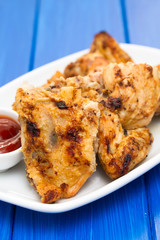 grilled chicken with sauce on dish