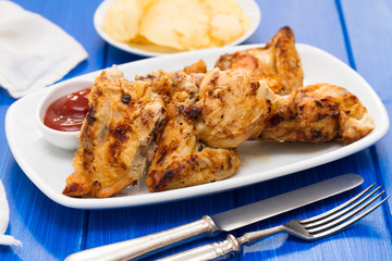 grilled chicken with sauce on dish