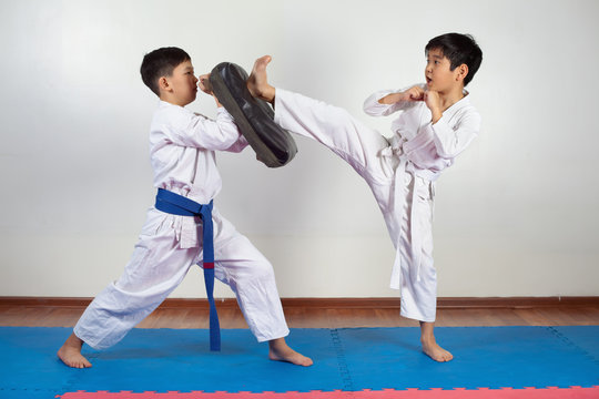 Two boys demonstrate martial arts working together