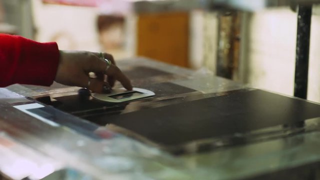 Screen printing, female worker manages the machine. 4k footage. 
