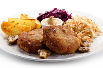 Fried steaks and potatoes with vegetalbes