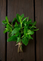 bunch of mint leaves on wooden surface