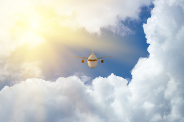 Fototapeta na wymiar Airplane plane in the blue sky with sunlight