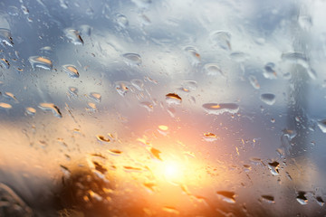 Rain water drops with sun  on glass  background