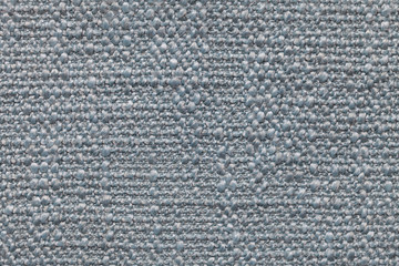 Blue knitted woolen background with a pattern of soft, fleecy cloth. Texture of textile closeup.