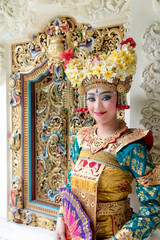 balinese legong dancer at decorative window