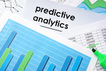 Predictive analytics written in a document and business charts.