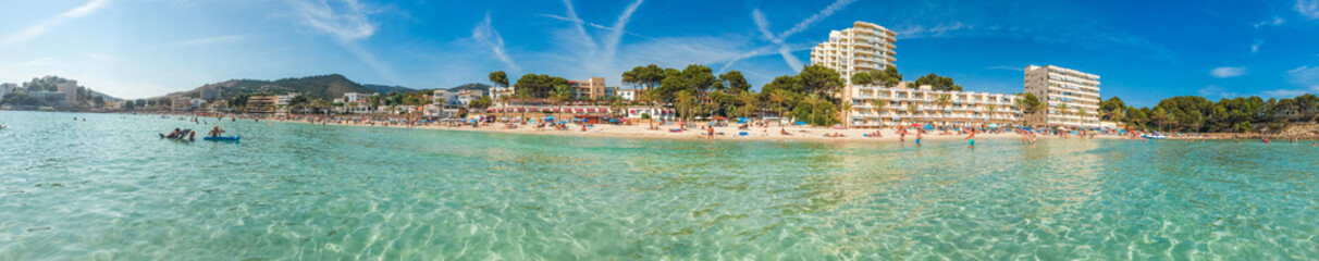 Fototapeta na wymiar beautiful panorama of beach at paguera with clear water and hotels in the background