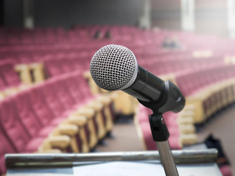 Microphone with blurred photo of conference hall background