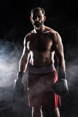 Fototapeta na wymiar Young boxer in gloves