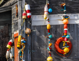 Fishing buoys in Homer Alaska decoratively hanging on wooded shed
