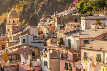 Old village in Italy as sunset shines on homes with laundry drying