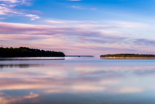 Lake at sunrise with vivid colors reflected in water of Lake Manitoulin