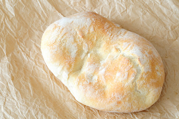 Typical Italian bread, ciabatta, on brown paper
