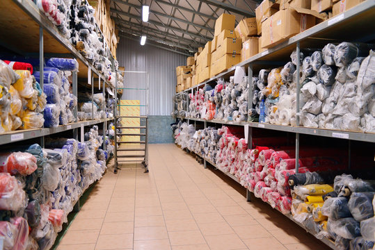 nterior of a industrial warehouse with fabric rolls.