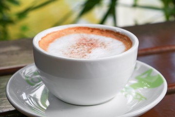 coffee cappuccino on the wood floor background