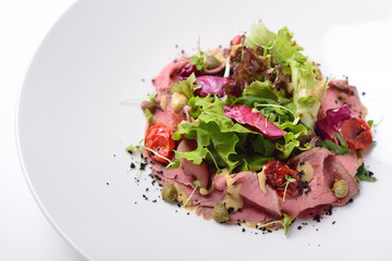salad with roast beef, tuna and anchovy sauce. Isolated