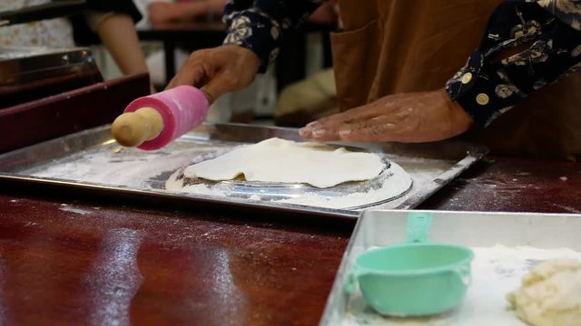 Street vendor cooking delicious pancakes for sale.