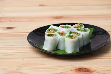 spring roll and vegetable  on banana leaf in plate, Select focus with shallow depth of field.