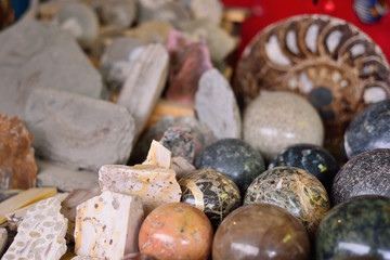 Fototapeta na wymiar stone balls of different minerals, ammonites, tourist souvenir