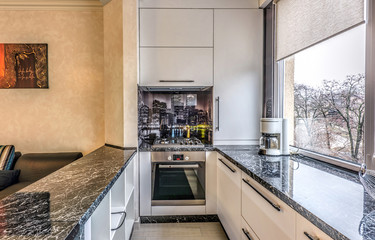 Contemporary modern black colored kitchen with fitted appliances and breakfast bar, chisinau, moldova
