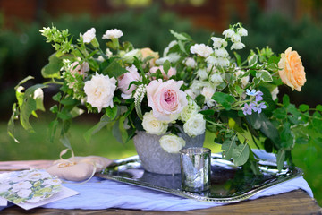 flower arrangement in silver bowl with pink and white roses