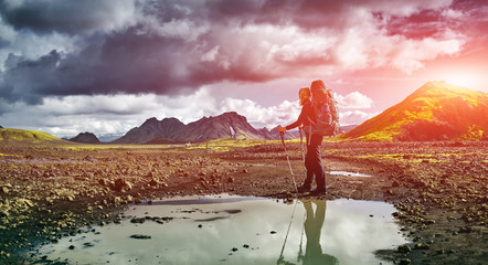 woman hiker on the trail in the Islandic mountains. Trek in National Park Landmannalaugar, Iceland....