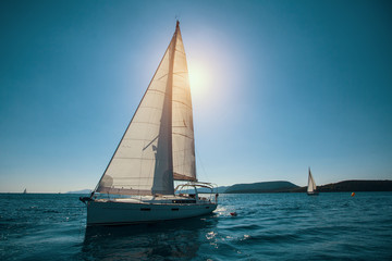 Obraz na płótnie Canvas Sailing ship luxury yacht with white sails in the Sea.
