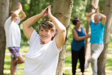 Happy senior woman working out in a park