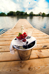 a bucket of champagne on the dock