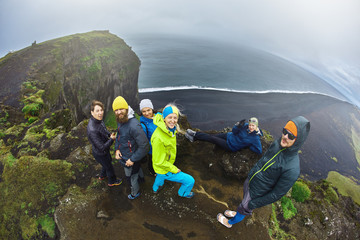 Rreykjavik, Iceland - August 29, 2016: Tourists setting on Dyrholaey Cliff Iceland - obrazy, fototapety, plakaty