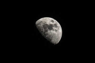 A clear half-moon with a lot of craters.