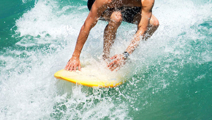 Close-Up ofsStaying low on a surfboard - obrazy, fototapety, plakaty