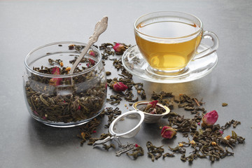 Spilled green tea with a rose on stone table