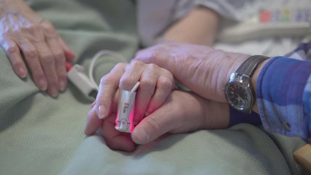Sad man says good bye as wife dies
