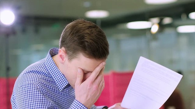 Clouse up of young businessman criticizes the work of a colleague