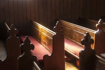 Church pews with window light illuminating