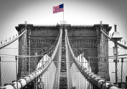 Fototapeta American flag on Brooklyn Bridge in New York City in Black and White