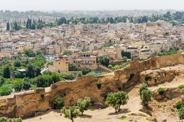 Fototapeta na wymiar Aerial view of historical Moroccan Arabic town Fez with its city wall and soukhs