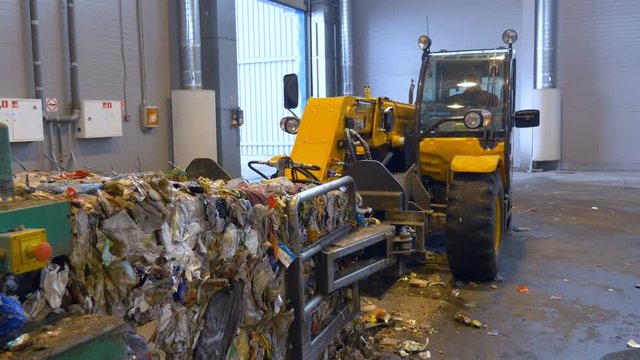 Lift truck, forklift loading a pile of trash on a truck. Special machinery working. 4K.