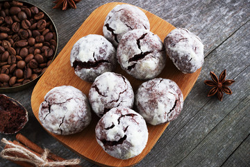 Chocolate cookies on wooden table with coffee bean, cocoa powder, cinnamon and star anise on wooden table.