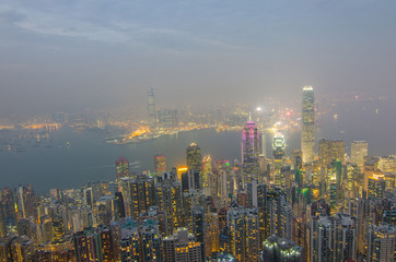 Fototapeta na wymiar Hong Kong the scenes, victoria harbour from the peak bird view, in the mist with bad weather in the night, nimbus landscape on the trails