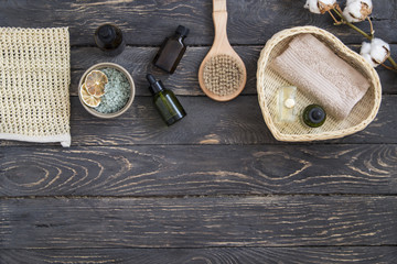Organic spa cosmetic and products on dark wooden background. Top view, copy space