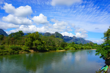 Fototapeta na wymiar Nam Song river, mountain, and beautiful sky in Vang Vieng, Laos