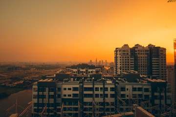 A construction site in the yellow sunset view from urban. HO CHI MINH CITY, VIETNAM- AUG 26