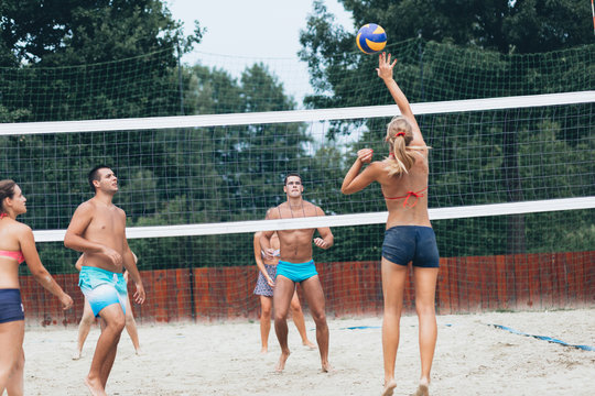 Beach volleyball, people outdoors.