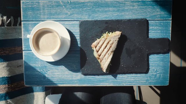 Young women eating hamburger or Sandwich in restaurant. Top view