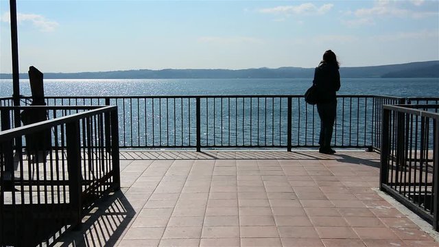 woman looks the Bracciano Lake - Trevignano (Italy)