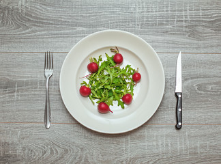 Rocket salad and radishes on a plate