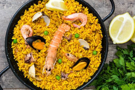 Traditional spanish seafood paella on wooden background.Top view
